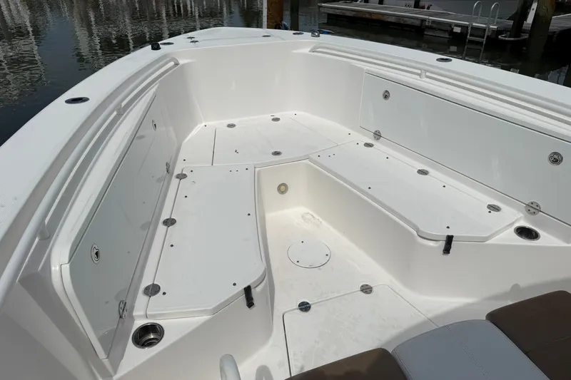 Slide: The Image of 2012 Everglades 325 Center Console boat interior with spacious seating and storage compartments. - 6