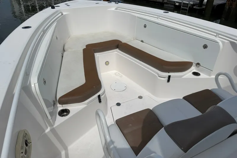 Slide: The Image of 2012 Everglades 325 Center Console boat interior with brown seating and white deck. - 19
