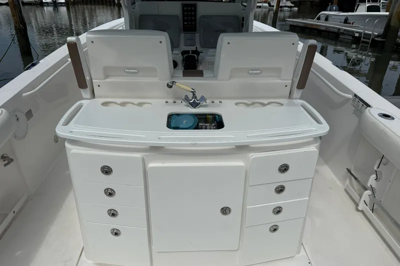 Slide: The Image of 2012 Everglades 325 Center Console boat interior with storage and sink. - 23