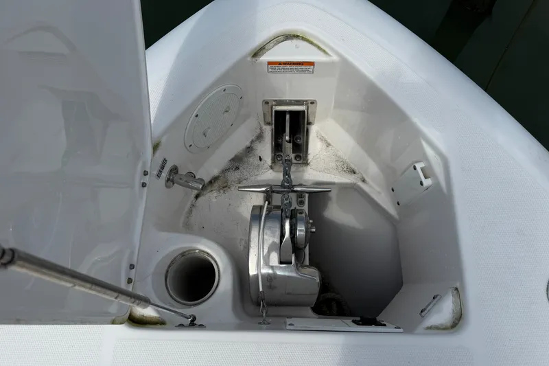 Slide: The Image of Anchor compartment of 2012 Everglades 325 Center Console boat, featuring winch and chain. - 5