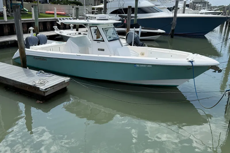 The Image of 2012 Everglades 325 Center Console boat docked in a marina. - 0