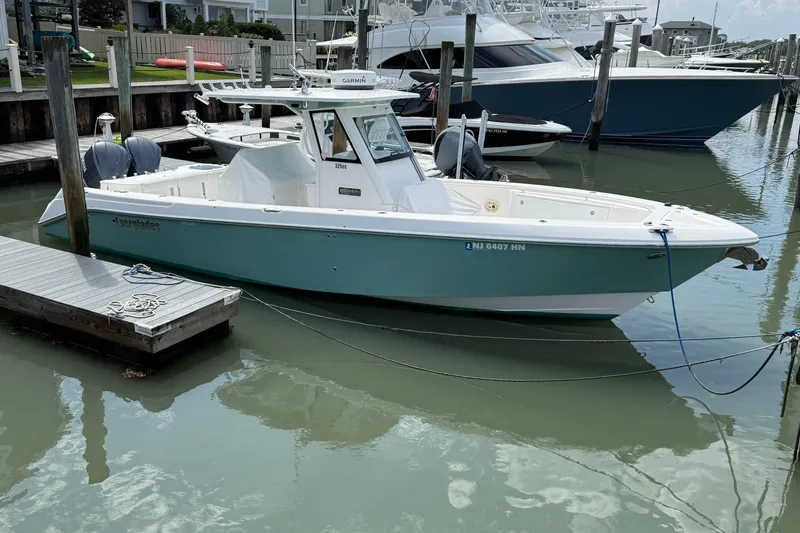 Slide: The Image of 2012 Everglades 325 Center Console boat docked in a marina. - 1