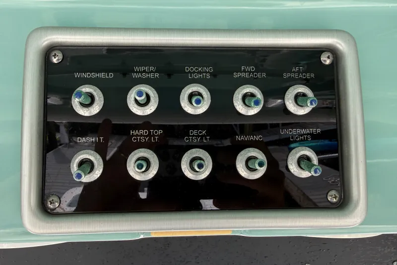 Slide: The Image of Control panel of a 2012 Everglades 325 Center Console boat with labeled switches. - 13