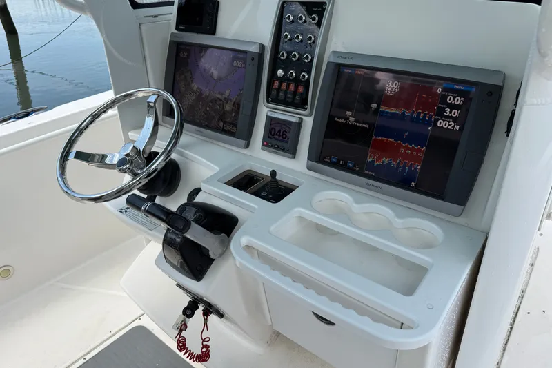 Slide: The Image of Control panel of a 2012 Everglades 325 Center Console boat with navigation screens. - 11