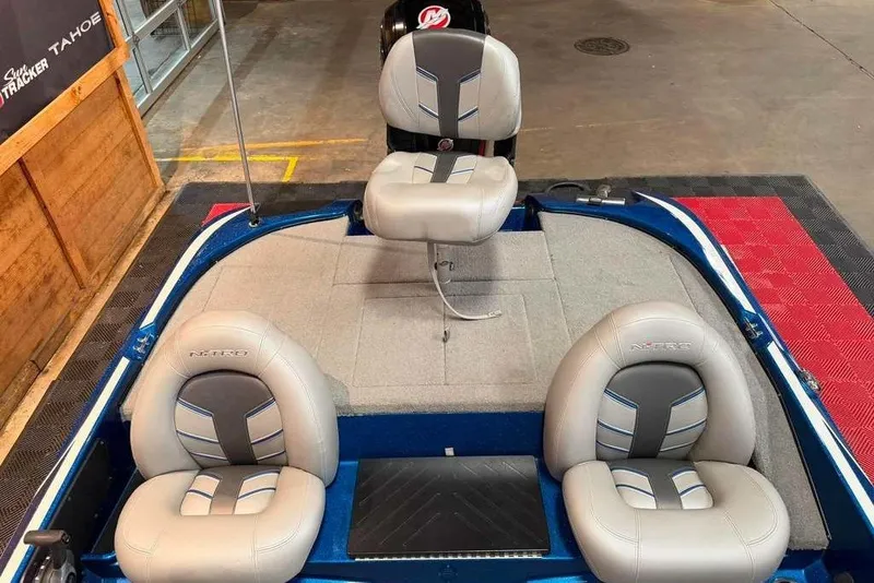 Slide: The Image of 2021 Nitro Z17 boat interior with three gray seats and blue accents. - 5