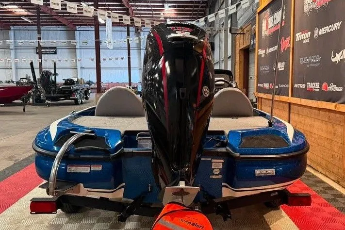 Slide: The Image of Blue Nitro Z17 boat, 2021 model, displayed indoors with powerful outboard motor. - 4