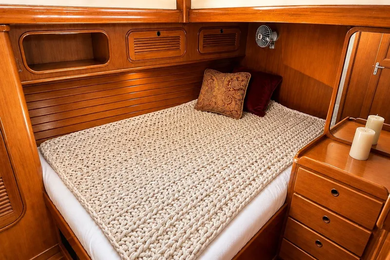 Slide: The Image of Cozy cabin interior of 1989 Mason 54 yacht with wooden finish and knitted bedspread. - 32