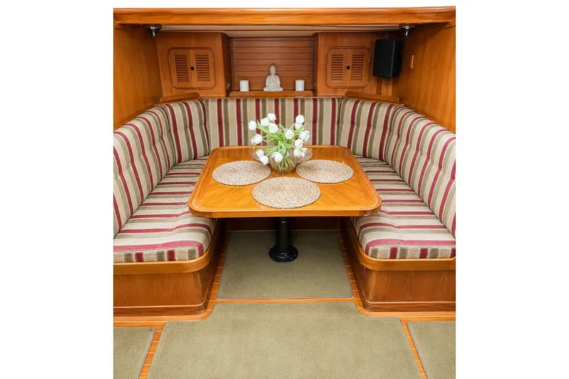 Slide: The Image of Cozy Mason 54 yacht interior with striped seating and wooden table, 1989 model. - 29
