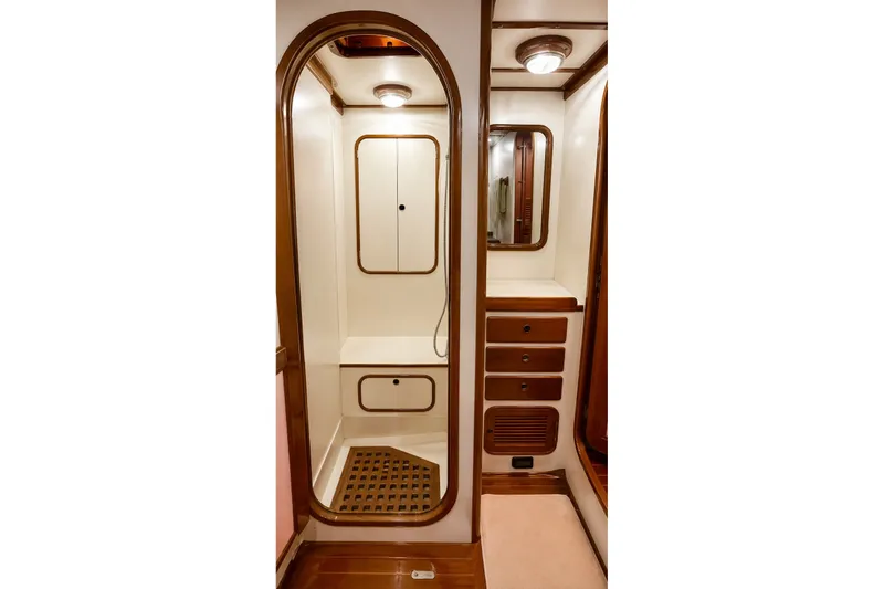 Slide: The Image of Luxurious 1989 Mason 54 yacht bathroom with wooden accents and built-in storage. - 40