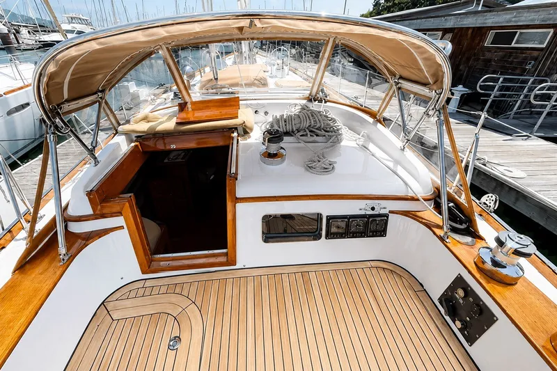 Slide: The Image of 1989 Mason 54 yacht cockpit with teak deck and canopy at marina. - 10
