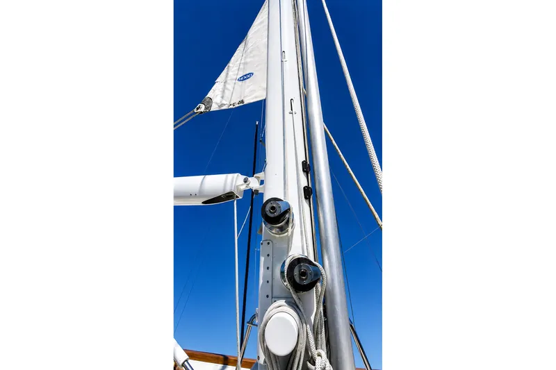 Slide: The Image of Close-up of a Mason 54 sailboat mast and rigging against a clear blue sky, 1989 model. - 14