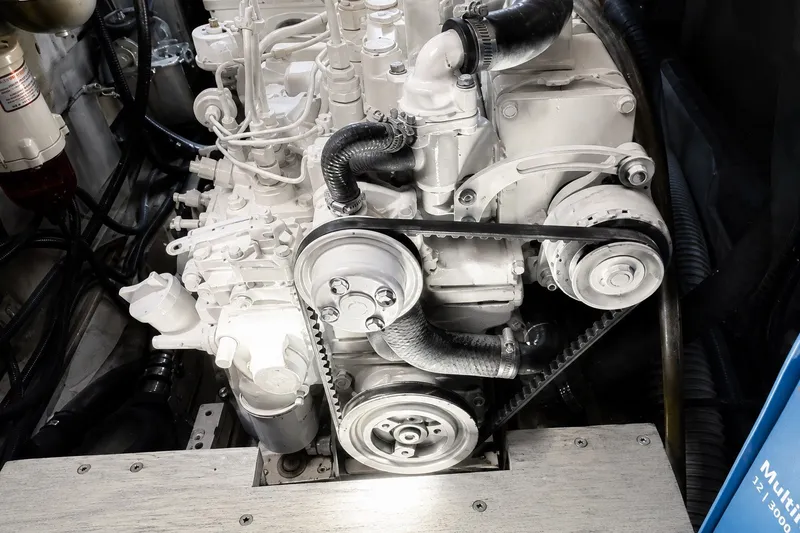 Slide: The Image of Engine of a 1989 Mason 54, showcasing belts and hoses in a mechanical setup. - 44