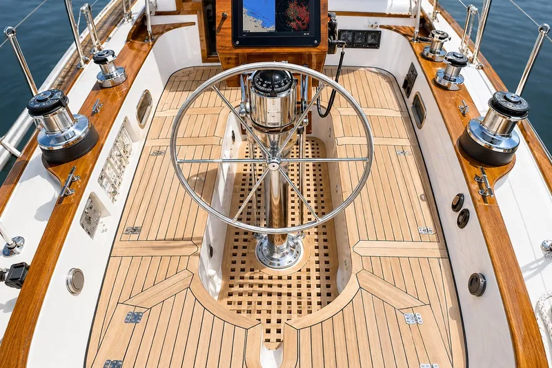 Slide: The Image of Elegant 1989 Mason 54 yacht cockpit with wooden deck and modern steering wheel. - 12