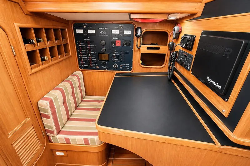 Slide: The Image of 1989 Mason 54 yacht interior with navigation panel, striped seating, and wooden cabinetry. - 23