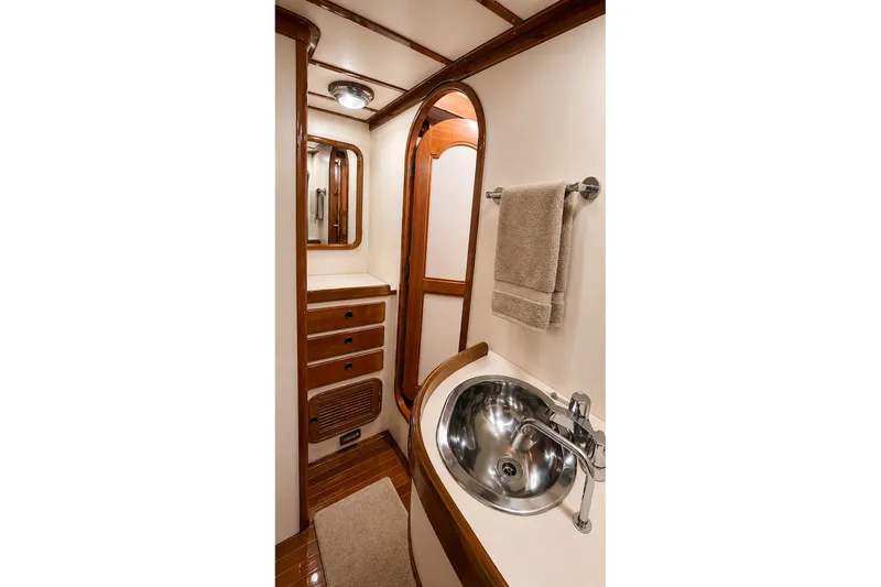 Slide: The Image of Luxurious 1989 Mason 54 yacht bathroom with wood accents and stainless steel sink. - 38