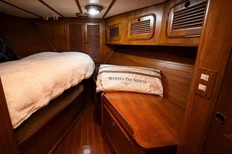 Slide: The Image of Cozy wooden cabin interior of 1989 Mason 54 yacht with bed and decorative pillow. - 35