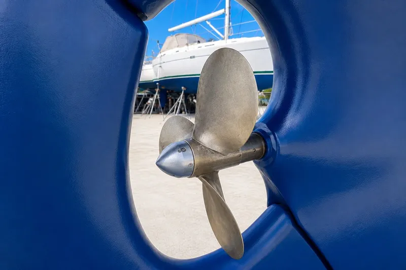 Slide: The Image of Close-up of a boat propeller with a yacht in the background, Mason 54, 1989 model. - 7