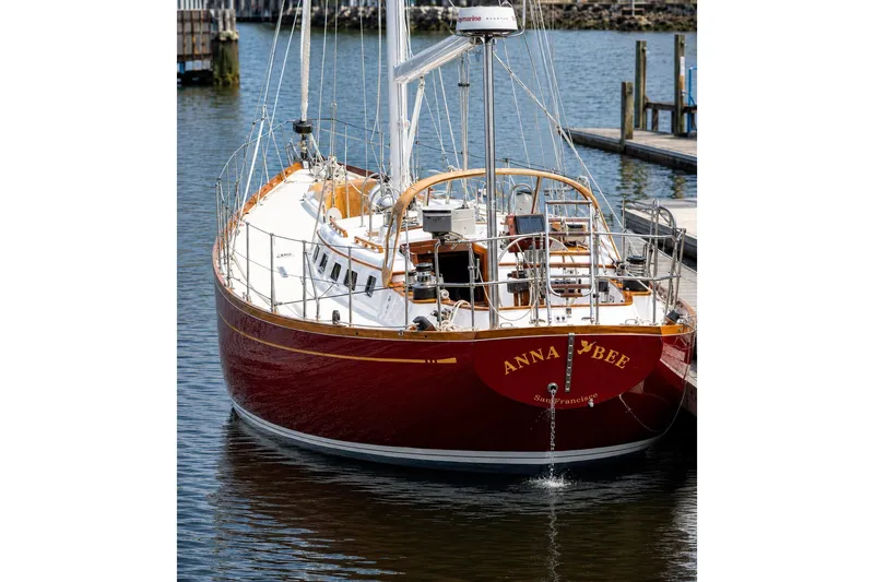 Slide: The Image of Red Mason 54 sailboat from 1989 docked in a marina, named "Anna Bee." - 4