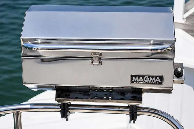 Slide: The Image of Stainless steel Magma Marine Kettle grill mounted on a boat railing. - 21