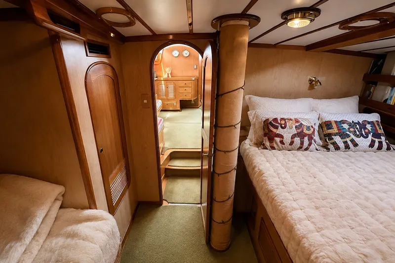 Slide: The Image of Luxurious 1989 Mason 54 yacht cabin with cozy bed and elegant wooden interior. - 34