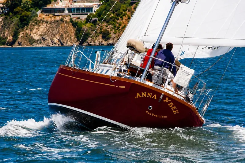 Slide: The Image of Sailing yacht "Anna Y Bee" on water, Mason 54 model, 1989, near rocky coastline. - 2