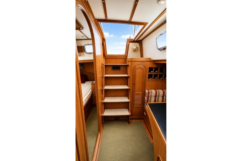 Slide: The Image of Interior of 1989 Mason 54 yacht with wooden stairs and cozy cabin design. - 22