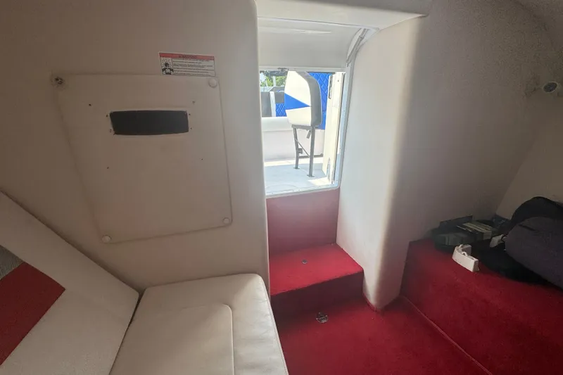 Slide: The Image of Interior cabin of a 2009 Donzi 27 ZR boat with red and white seating. - 33