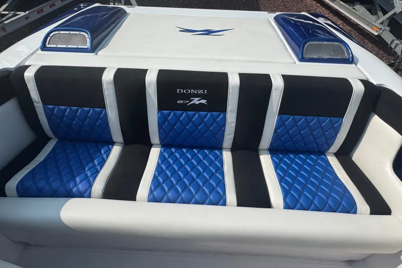 Slide: The Image of 2009 Donzi 27 ZR boat interior with blue and black quilted seating. - 16
