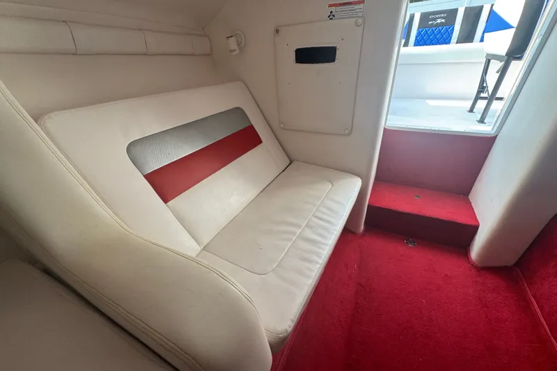 Slide: The Image of Interior of 2009 Donzi 27 ZR boat with white seating and red carpet. - 31