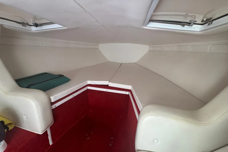 Slide: The Image of Interior cabin of 2009 Donzi 27 ZR boat with white seating and red carpet. - 29