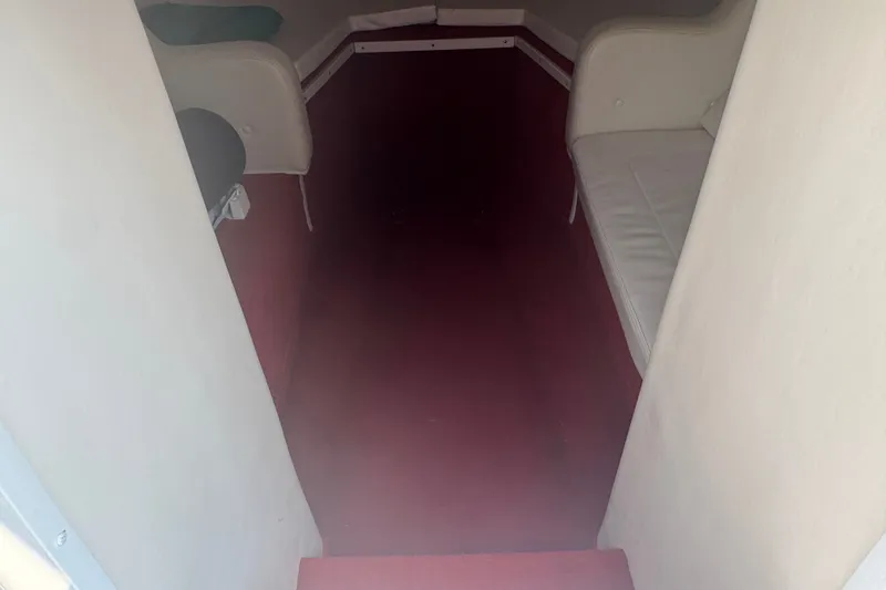 Slide: The Image of Interior cabin of a 2009 Donzi 27 ZR boat with red flooring and white seating. - 28