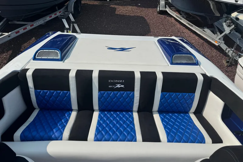 Slide: The Image of 2009 Donzi 27 ZR boat interior with blue and black quilted seating. - 13