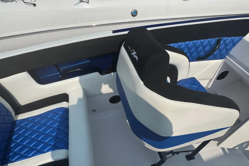 Slide: The Image of 2009 Donzi 27 ZR boat interior with blue and white seating, featuring quilted design. - 17