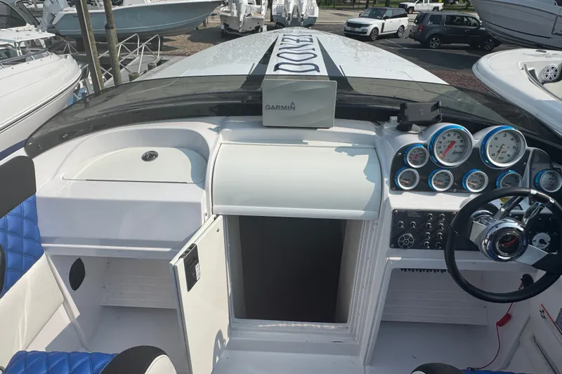 Slide: The Image of 2009 Donzi 27 ZR boat cockpit with Garmin navigation and blue seating. - 27