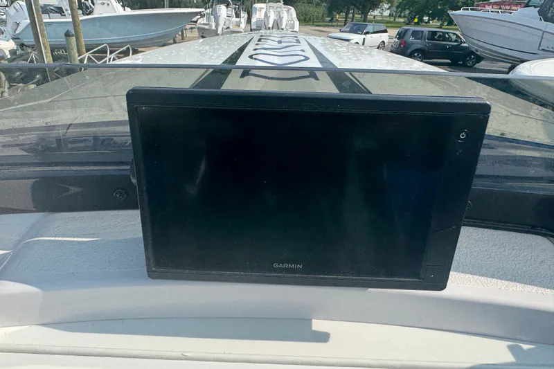 Slide: The Image of Garmin navigation system on 2009 Donzi 27 ZR boat dashboard, marina background. - 25