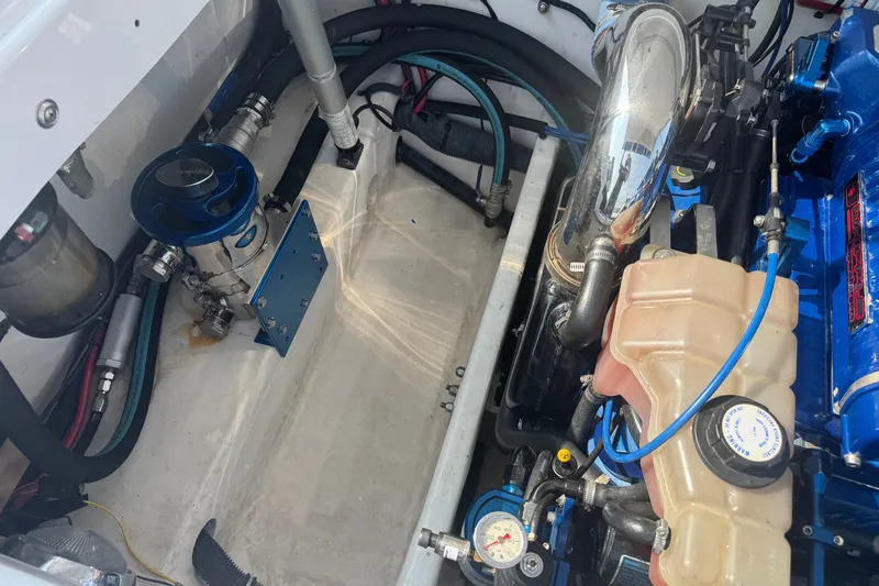 Slide: The Image of Engine compartment of a 2009 Donzi 27 ZR boat, showcasing mechanical components. - 11