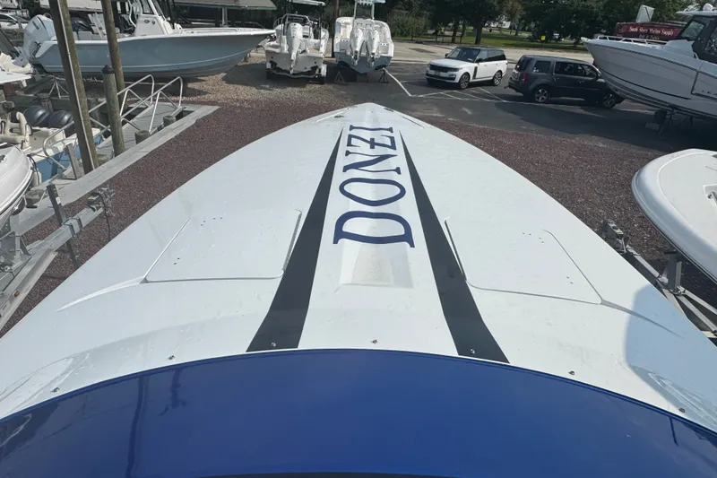 Slide: The Image of 2009 Donzi 27 ZR boat with bold branding, parked in a marina. - 26