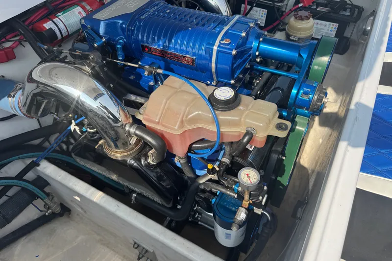 Slide: The Image of Engine compartment of a 2009 Donzi 27 ZR boat, featuring a powerful blue engine. - 7
