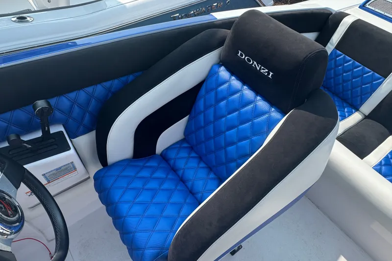 Slide: The Image of Interior of 2009 Donzi 27 ZR boat with blue quilted seats and steering wheel. - 20