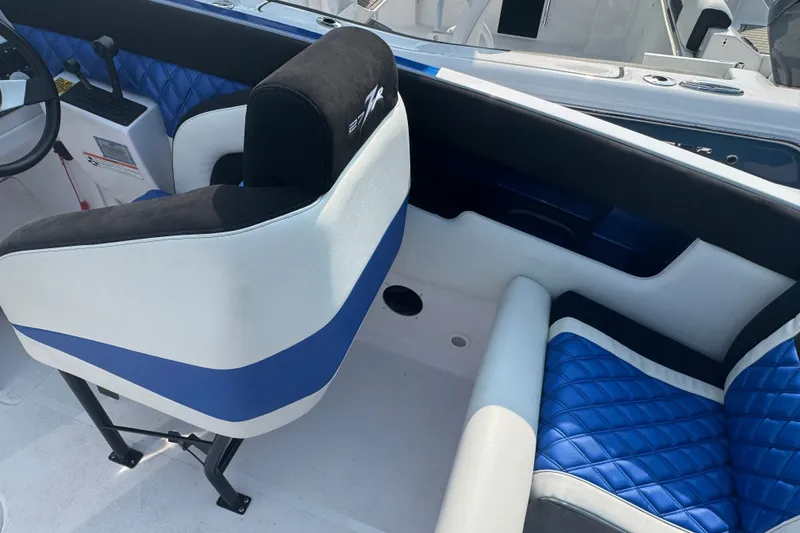 Slide: The Image of Interior of 2009 Donzi 27 ZR boat with blue and white seating. - 18