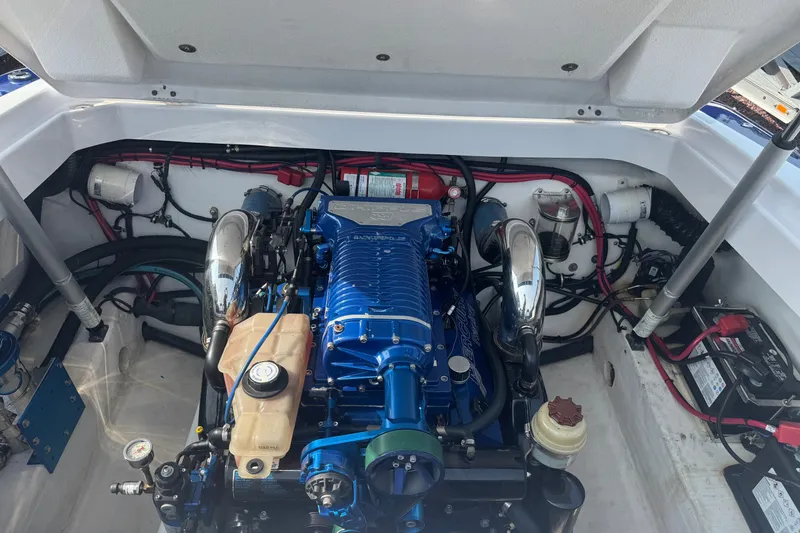 Slide: The Image of Engine compartment of a 2009 Donzi 27 ZR boat, showcasing detailed components. - 12