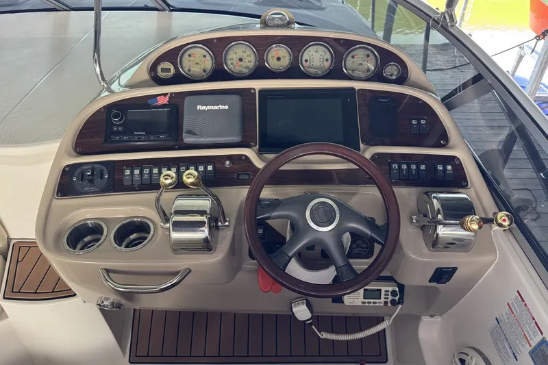 Slide: The Image of Control panel of a 2005 Chaparral Signature 350 boat with steering wheel and gauges. - 8