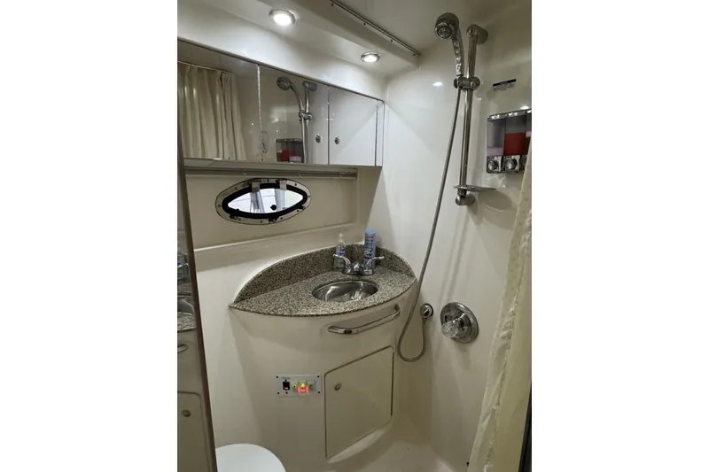 Slide: The Image of 2005 Chaparral Signature 350 yacht bathroom with shower, sink, and mirror. - 16