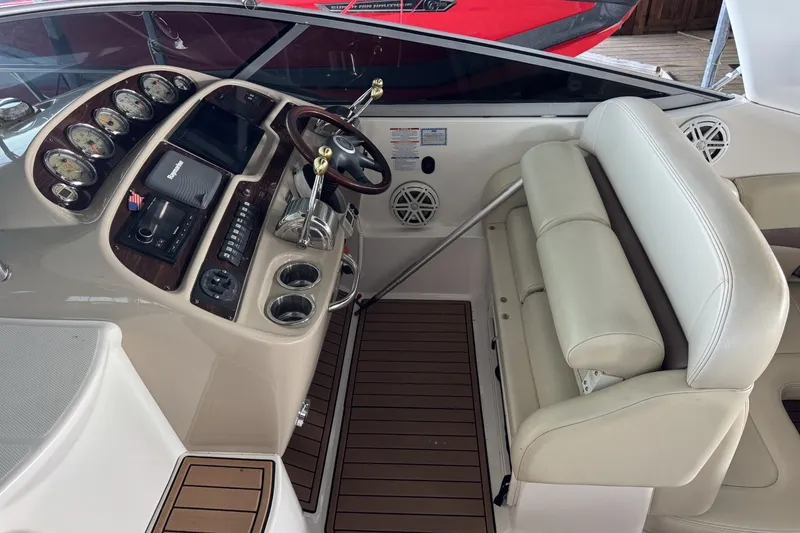 Slide: The Image of 2005 Chaparral Signature 350 boat cockpit with steering wheel, gauges, and beige seating. - 9