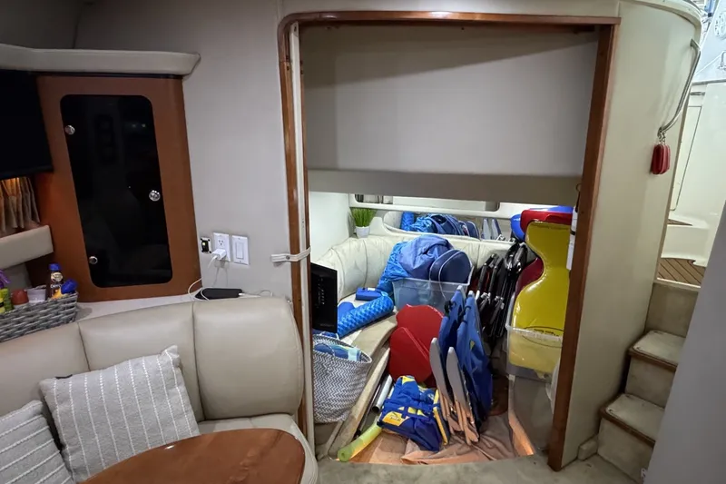 Slide: The Image of Interior of a 2005 Chaparral Signature 350 boat with stored life jackets and equipment. - 14