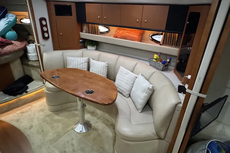 Slide: The Image of Interior of 2005 Chaparral Signature 350 yacht with cozy seating and wooden table. - 11