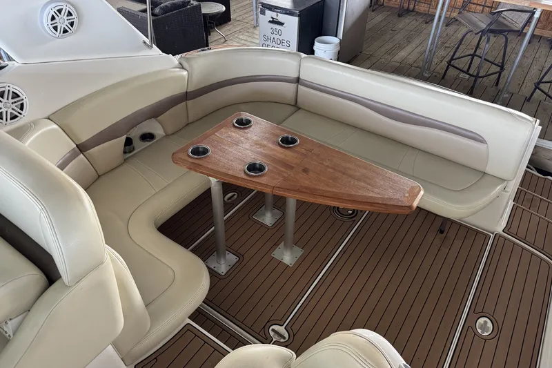 Slide: The Image of 2005 Chaparral Signature 350 boat interior with beige seating and wooden table. - 7