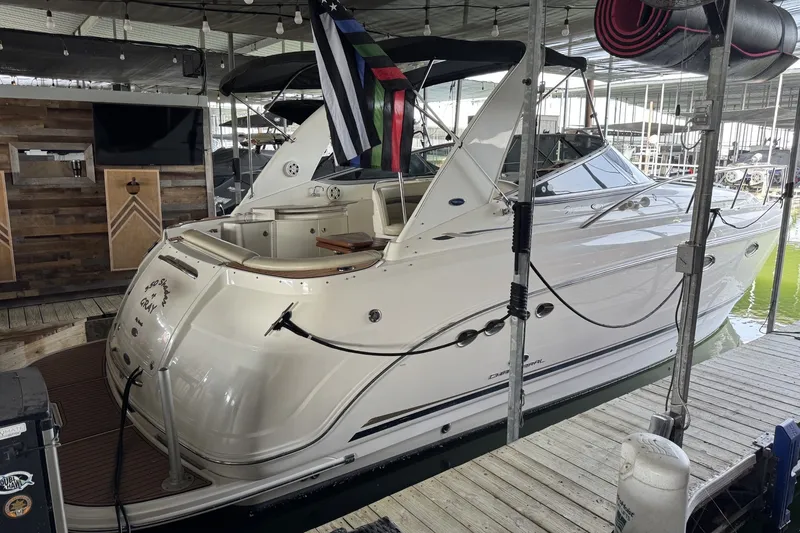 Slide: The Image of 2005 Chaparral Signature 350 boat docked in a marina, featuring sleek white design. - 1