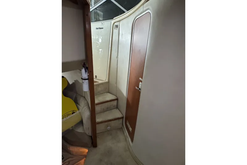 Slide: The Image of Interior of 2005 Chaparral Signature 350 boat, featuring stairs and a wooden door. - 15