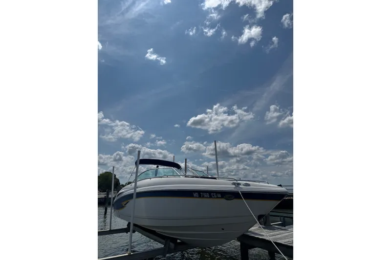 The Image of 2003 CHAPPARRAL 260 SSI boat docked under a partly cloudy sky. - 0